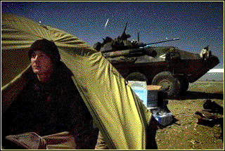 Lance Cpl. Jason Haislar scans the horizon at the Marine base at Kandahar International Airport on December 24, 2001.