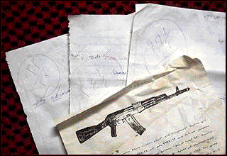 Graded terrorist tests are shown with training literature after they were discovered Thursday in a cave at an al-Qaida training camp west of Kandahar, Afghanistan.