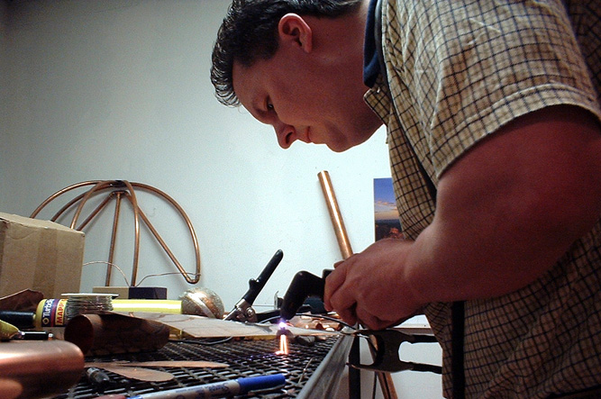 Anthony forms a dragon fly in copper using a plasma torch